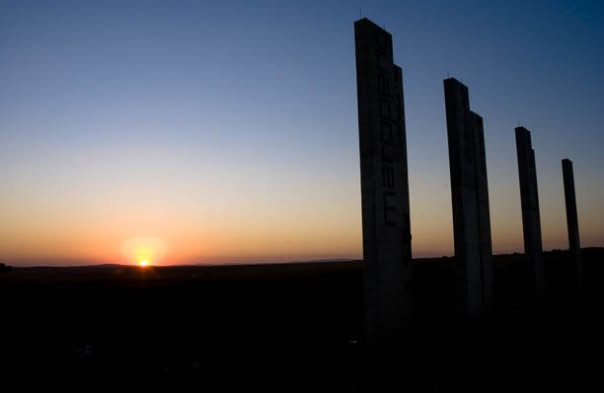 Maropeng — welcome monoliths silhouetted at sunset